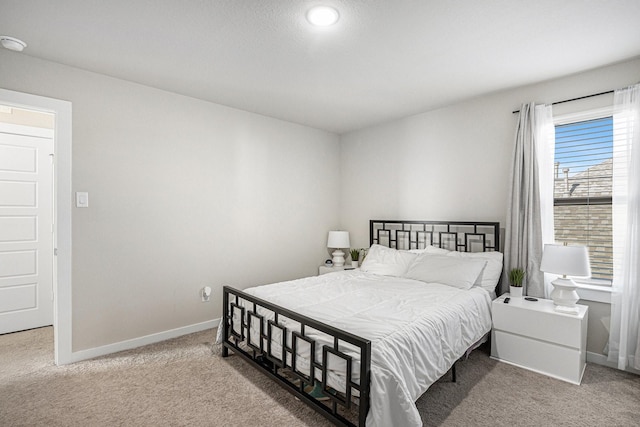 carpeted bedroom with baseboards