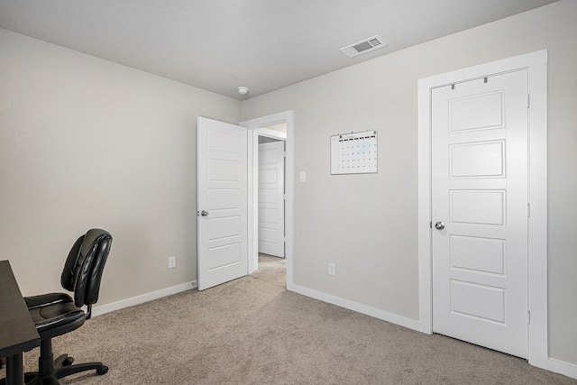 unfurnished office featuring light colored carpet