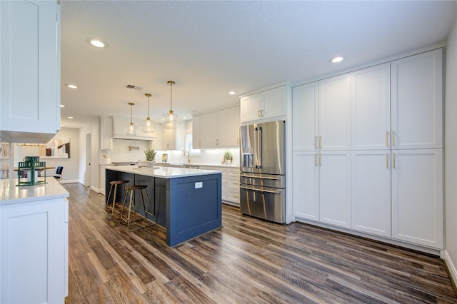 kitchen featuring pendant lighting, dark hardwood / wood-style floors, white cabinetry, and high end refrigerator