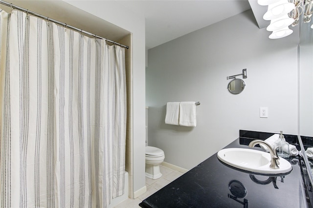 bathroom featuring a chandelier, tile patterned floors, vanity, and toilet