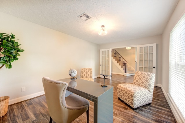 office featuring dark hardwood / wood-style flooring, french doors, and a textured ceiling