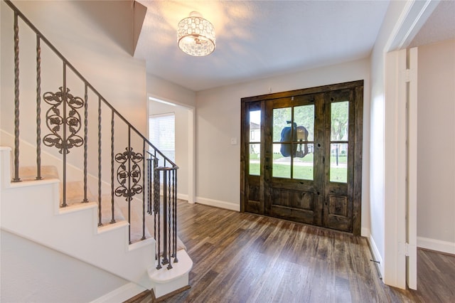 entryway featuring a notable chandelier and dark wood-type flooring