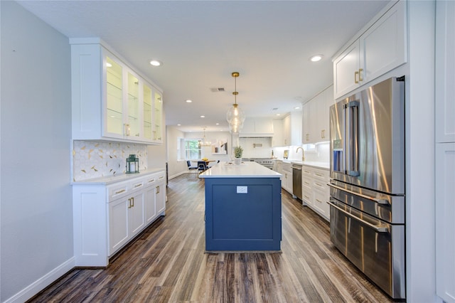 kitchen featuring white cabinets, a center island, stainless steel appliances, and dark hardwood / wood-style floors