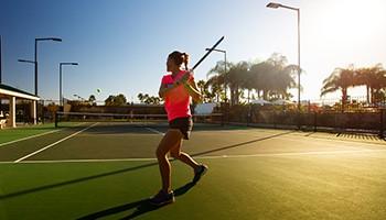 view of tennis court with basketball hoop