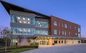 view of outdoor building at dusk