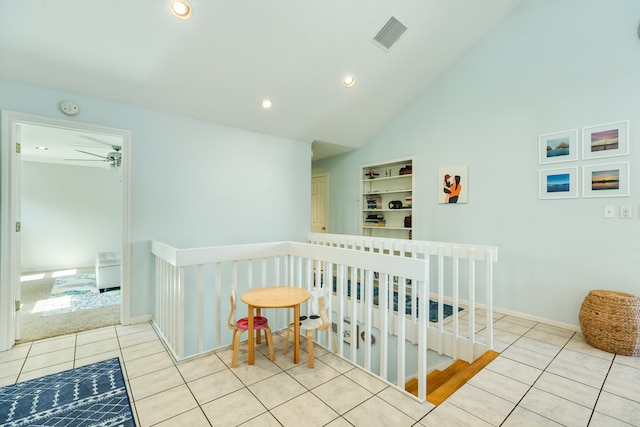 bedroom featuring light tile patterned flooring and high vaulted ceiling