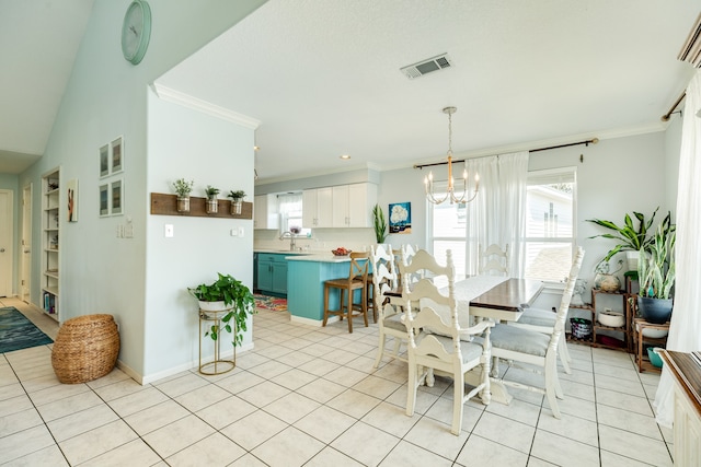 dining area with an inviting chandelier, light tile patterned flooring, crown molding, and sink