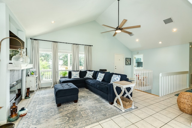 living room featuring high vaulted ceiling, light tile patterned floors, and ceiling fan