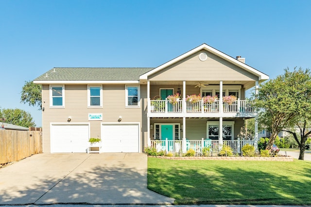 view of front facade with a front yard, a garage, a porch, and a balcony