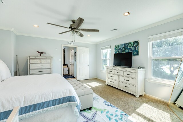 carpeted bedroom with ceiling fan and crown molding