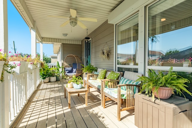 wooden balcony featuring a deck and ceiling fan