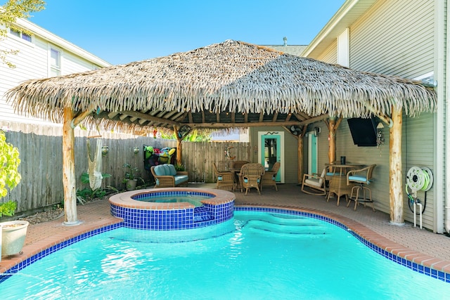 view of pool featuring a gazebo, an in ground hot tub, and a patio area