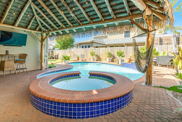 view of swimming pool with a gazebo, an in ground hot tub, and a patio area