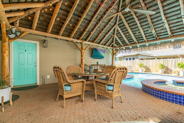 view of patio / terrace featuring ceiling fan, a pool with hot tub, and a gazebo