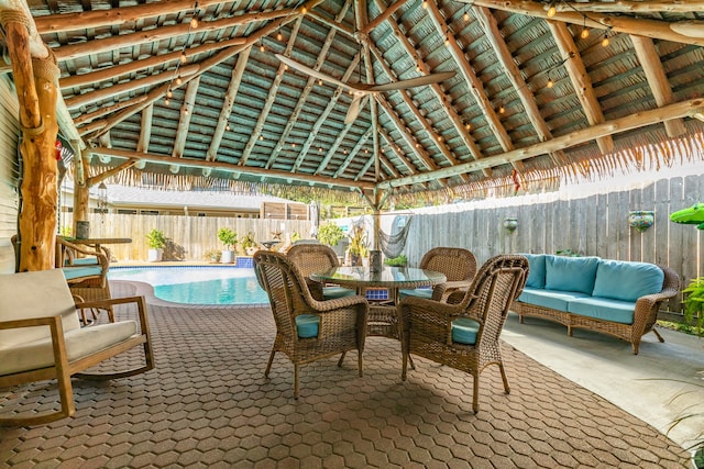 view of patio with an outdoor hangout area, a fenced in pool, and a gazebo