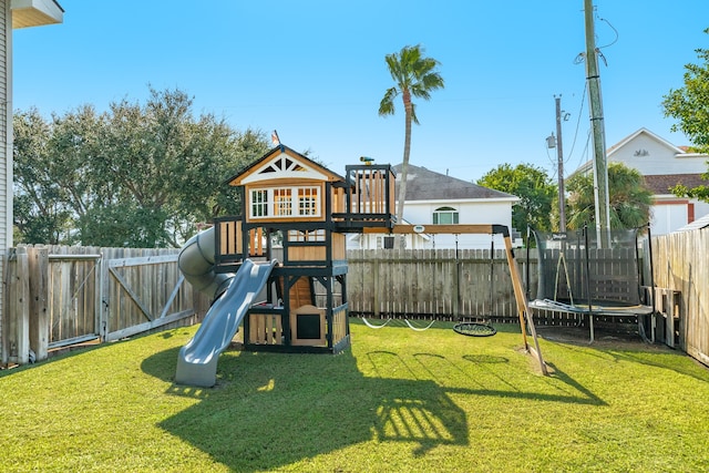 view of play area featuring a trampoline and a lawn