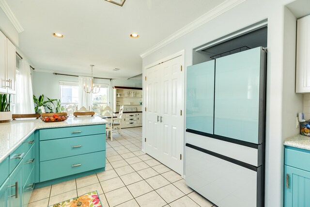 kitchen with white cabinets, white fridge, crown molding, pendant lighting, and light tile patterned floors