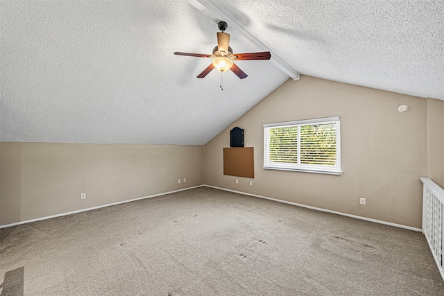 additional living space with ceiling fan, carpet flooring, lofted ceiling with beams, and a textured ceiling