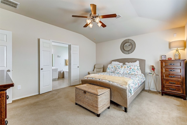 bedroom featuring lofted ceiling, ceiling fan, ensuite bathroom, and light colored carpet