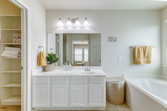 bathroom featuring a bathtub, tile patterned floors, and vanity