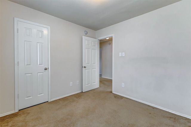 unfurnished bedroom with light colored carpet