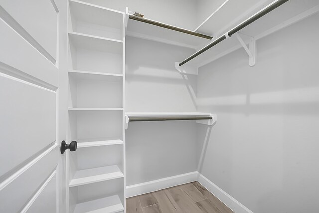 spacious closet with light hardwood / wood-style floors