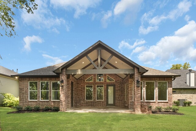 rear view of property with central AC unit, a yard, and a patio