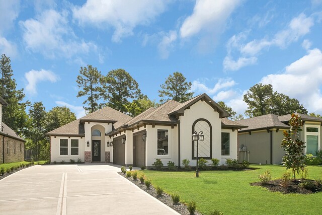 view of front of property with a front lawn and a garage