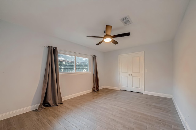 unfurnished room with ceiling fan and light hardwood / wood-style floors