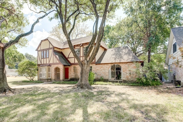 english style home featuring a front lawn