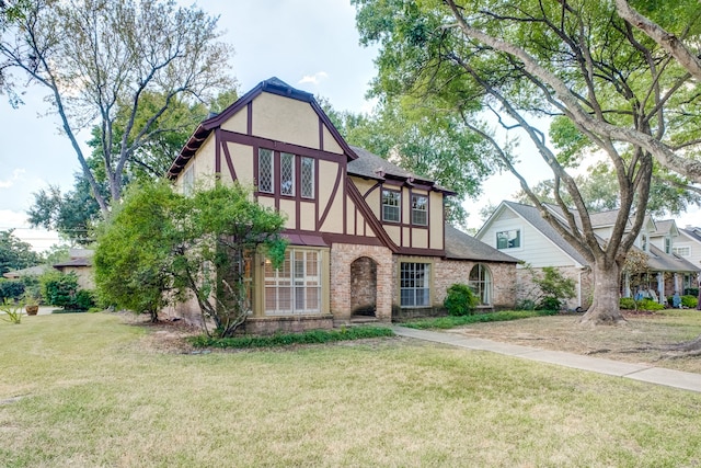 english style home with a front yard