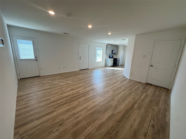 unfurnished living room with light hardwood / wood-style floors