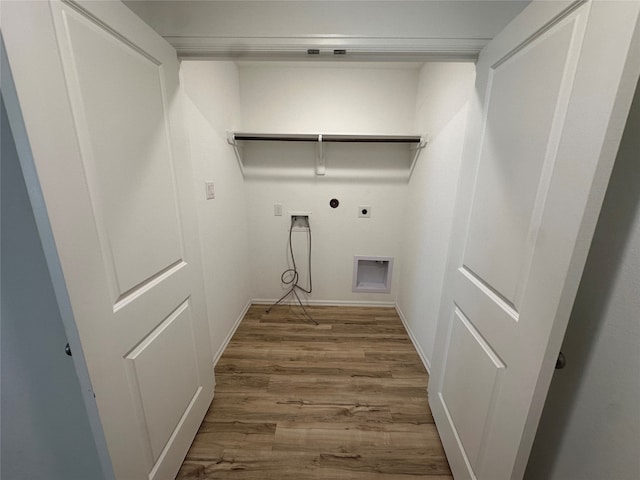 laundry area with hookup for a gas dryer, hookup for an electric dryer, and wood-type flooring