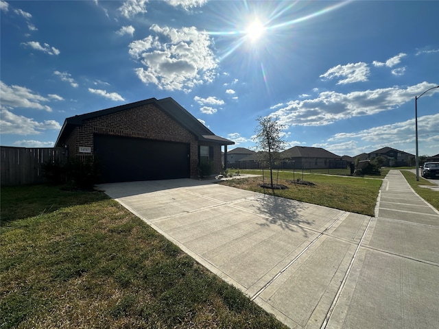 view of front of property featuring a front yard and a garage