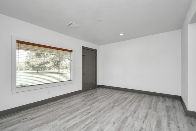 empty room with light hardwood / wood-style flooring