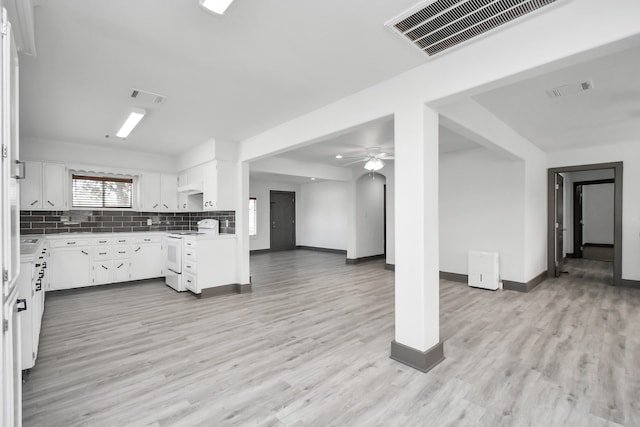 kitchen featuring electric range, decorative backsplash, ceiling fan, light wood-type flooring, and white cabinetry