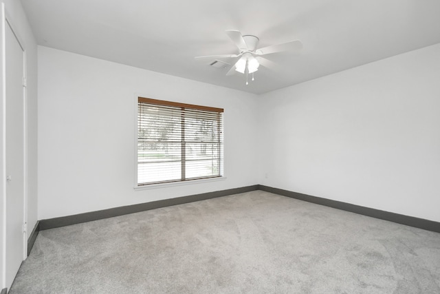 unfurnished room featuring ceiling fan and light colored carpet