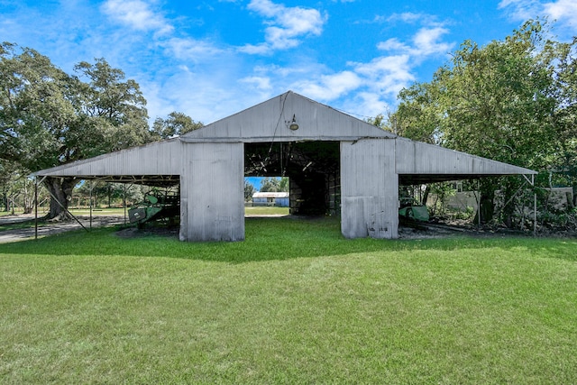 view of outbuilding featuring a yard