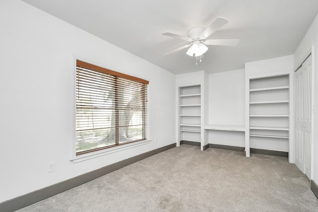 walk in closet featuring ceiling fan and light carpet