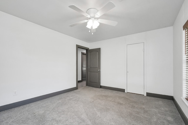 unfurnished bedroom with ceiling fan, light carpet, and a closet