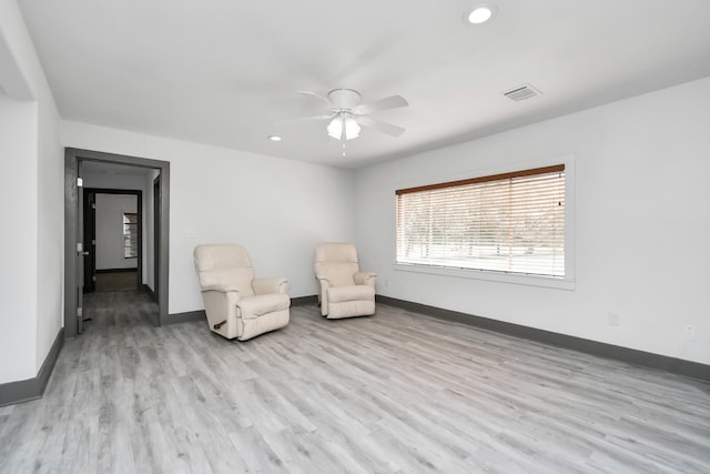 unfurnished room with ceiling fan and light wood-type flooring