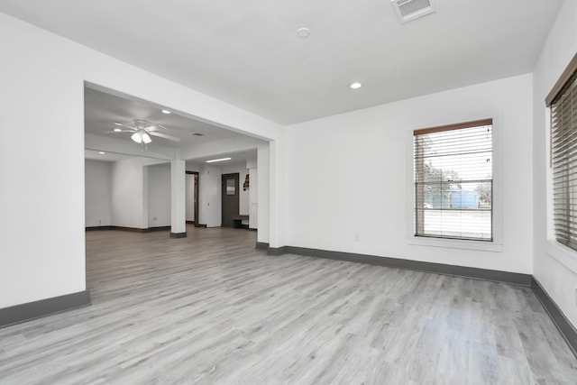 unfurnished living room featuring ceiling fan and light hardwood / wood-style floors