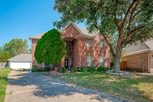 view of front of property with a garage and a front lawn