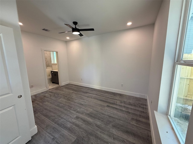 empty room with ceiling fan and dark wood-type flooring