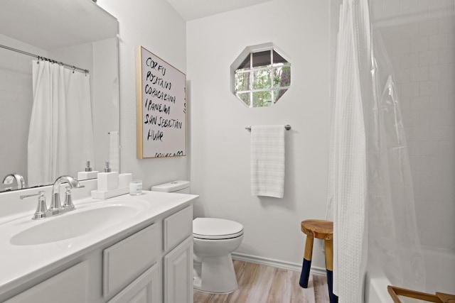 full bathroom featuring wood-type flooring, shower / tub combo, vanity, and toilet