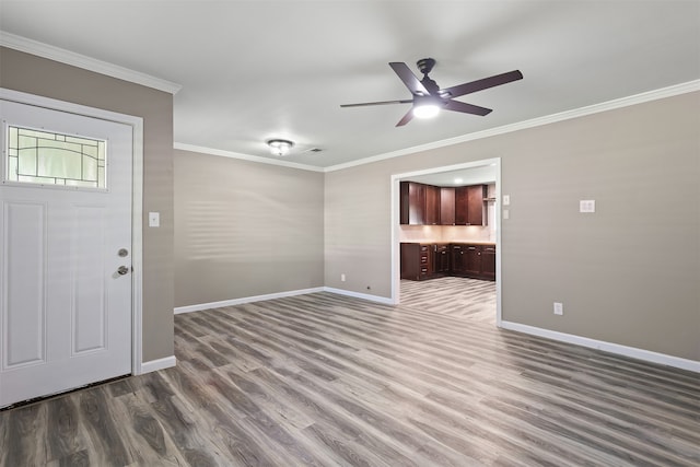 entrance foyer featuring crown molding, ceiling fan, and hardwood / wood-style floors