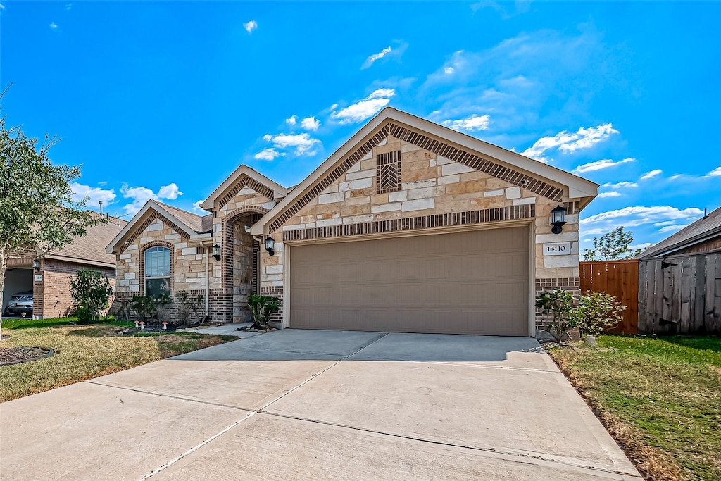 view of front of home featuring a garage and a front lawn