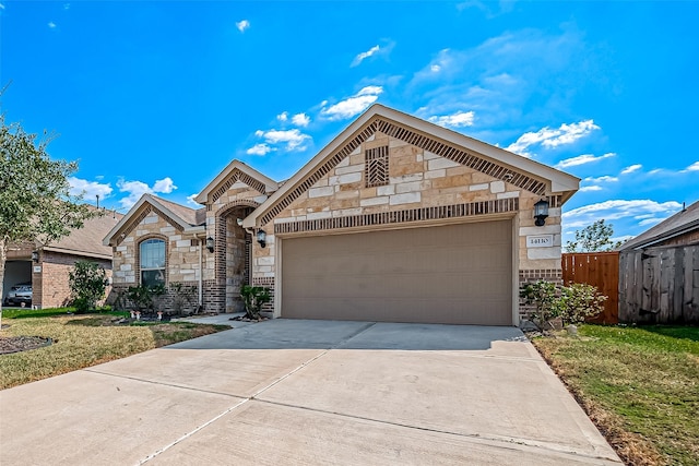 view of front of home featuring a garage and a front lawn