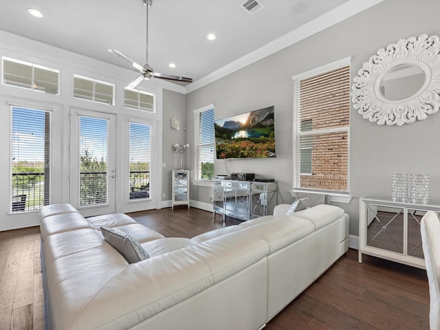 living room with crown molding, dark hardwood / wood-style flooring, and ceiling fan