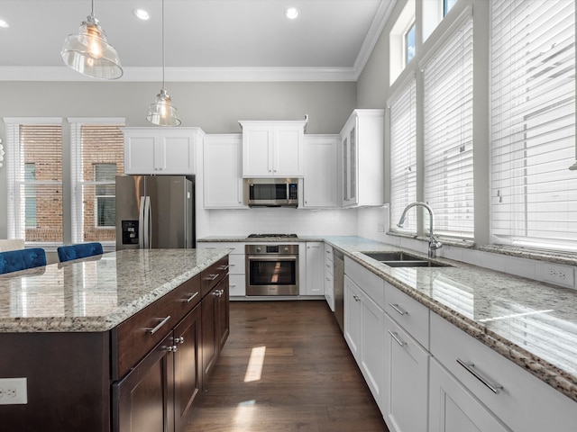 kitchen with dark wood-type flooring, sink, crown molding, white cabinetry, and appliances with stainless steel finishes